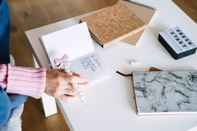 Midsection of man working on table
