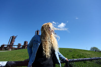 Curly blonde hair hispanic woman standing in front of the old factory at gas works park in seattle