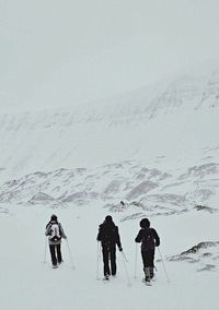 Tourists on snow covered landscape