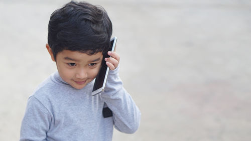 Portrait of boy standing outdoors