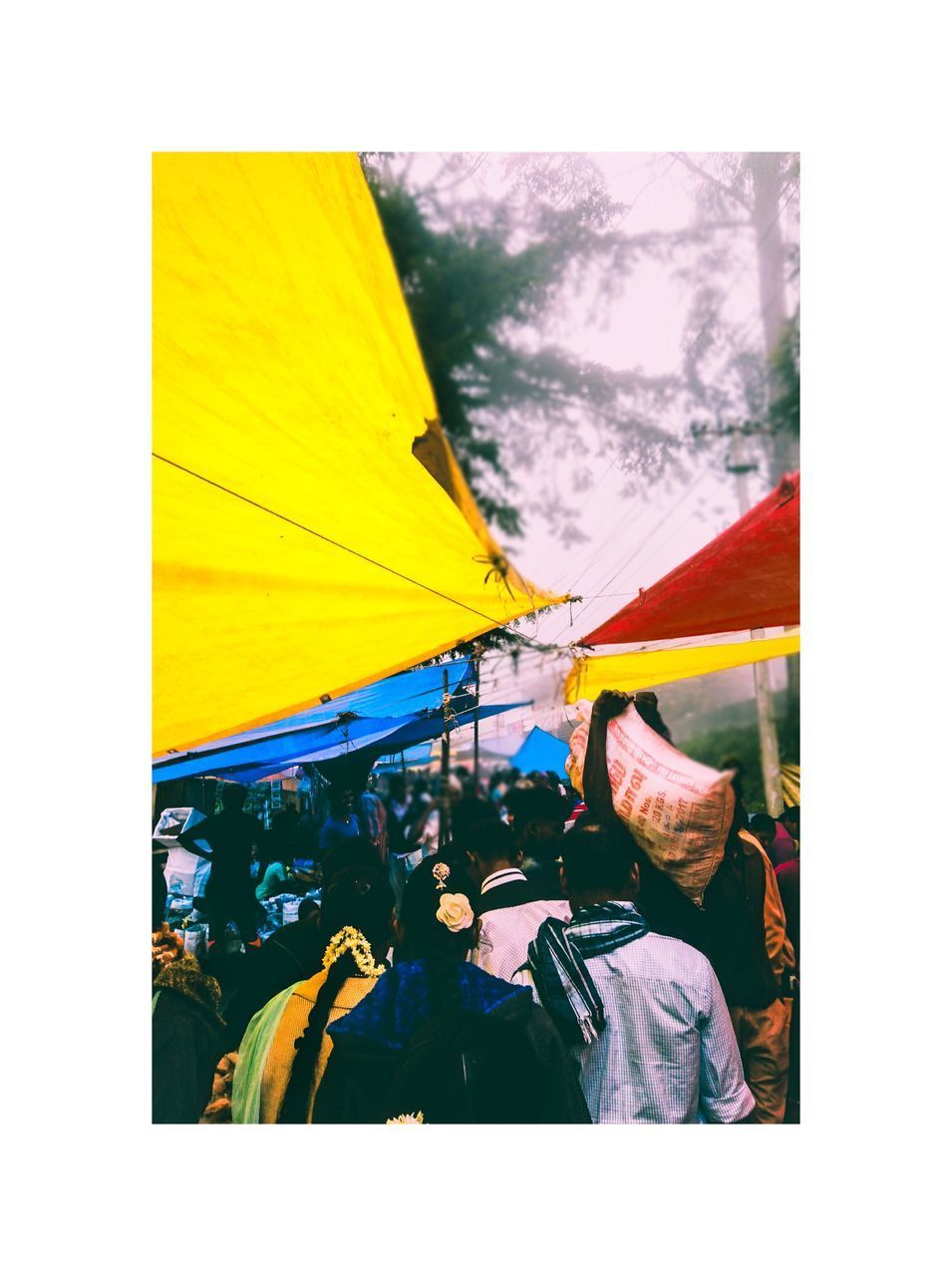 CLOSE-UP OF YELLOW TENT AGAINST CLOUDY SKY