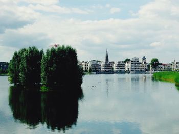 Reflection of trees in river against sky