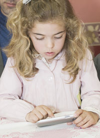 Close-up of girl using mobile phone