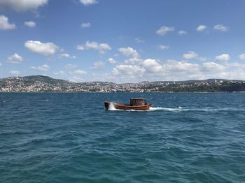 Boat sailing in sea against sky