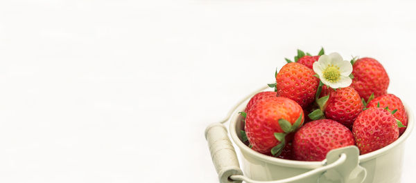 Close-up of strawberries in bowl against white background