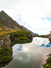 Scenic view of lake and mountains against sky