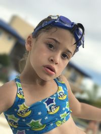 Cute girl wearing swimwear on poolside