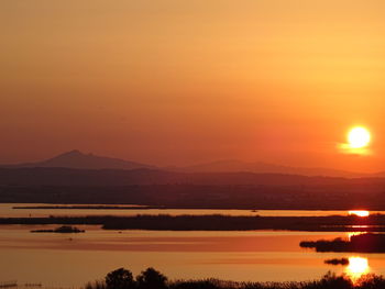 Scenic view of sea against orange sky