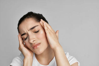 Portrait of woman against white background