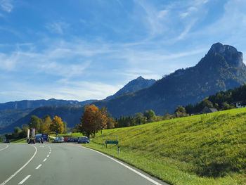 Road amidst trees against sky