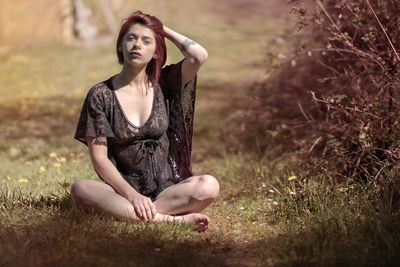 Young woman sitting on field