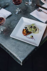 Crostini appetizer at outdoor restaurant with wine glasses