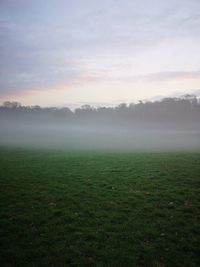 Scenic view of landscape against sky during foggy weather