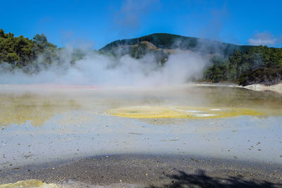 Scenic view of smoke emitting from volcanic mountain