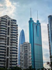 Modern buildings in city against sky