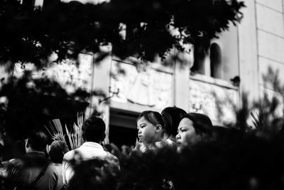 People standing by plants in city