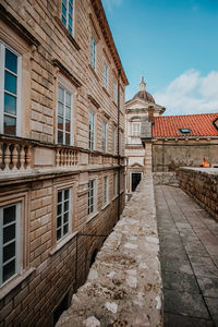 Exterior of old building in town against sky