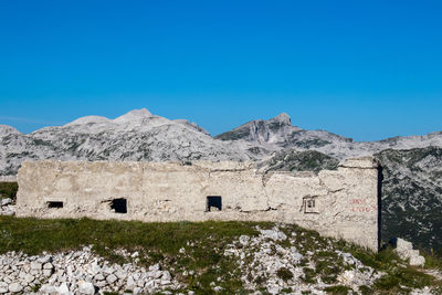 Built structure on mountain against clear blue sky