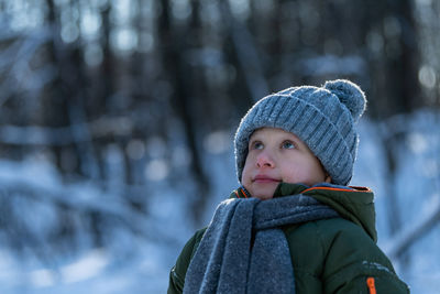 Cute boy looking away during winter