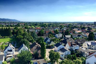 High angle view of houses in town against sky