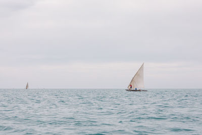 Sailboat sailing on sea against clear sky