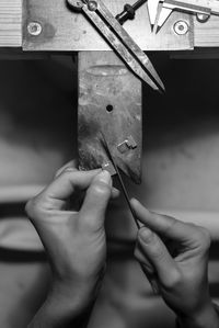 Cropped image of hands working at factory