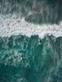 Aerial view of men surfing on sea