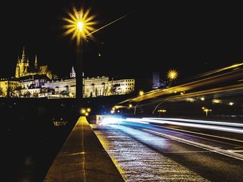 Light trails on road against sky at night