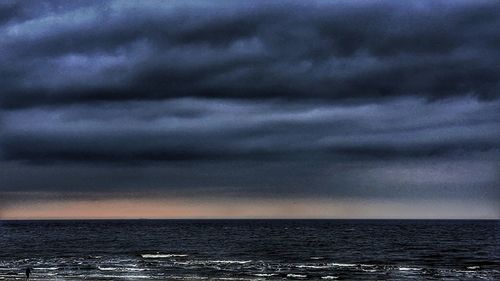 Scenic view of sea against dramatic sky