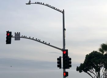 Low angle view of road sign against sky