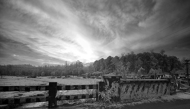 sky, cloud - sky, cloud, cloudy, mountain, tranquil scene, landscape, nature, tranquility, scenics, tree, building exterior, beauty in nature, built structure, weather, fence, house, outdoors, railing, water