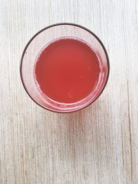 High angle view of red drink on table