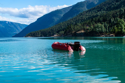 View of boat in lake against mountains