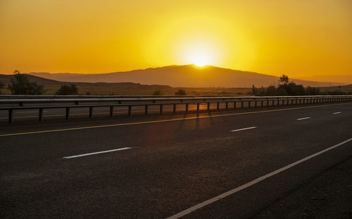 Scenic view of road against sky during sunset