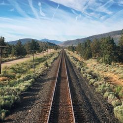 High angle view of railroad track amidst trees against sky