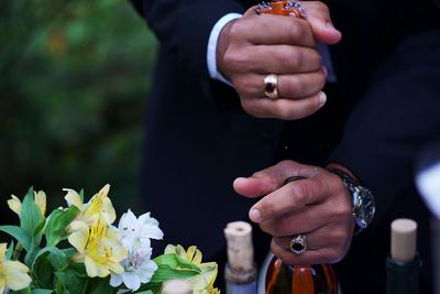 Cropped image of people holding hands at dusk