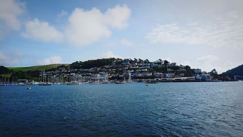 Panoramic view of sea and townscape against sky