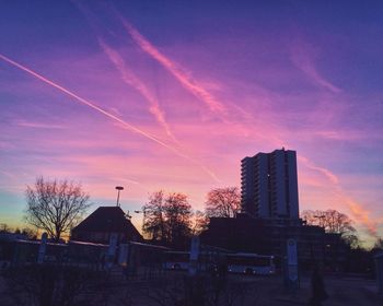 Low angle view of buildings against sky at sunset