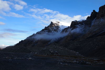 Scenic view of snow capped mountains against sky