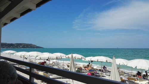 Scenic view of beach against blue sky