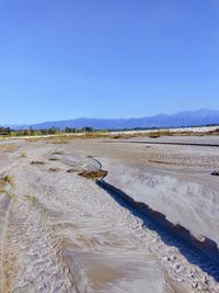 Scenic view of land against clear blue sky