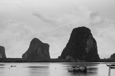 Rock formation in sea against sky