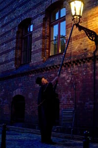 Man standing by window of building