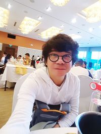 Portrait of friends sitting on table at restaurant