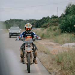 Man riding motorcycle on road