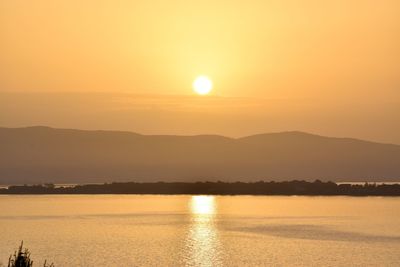 Scenic view of sea against romantic sky at sunset
