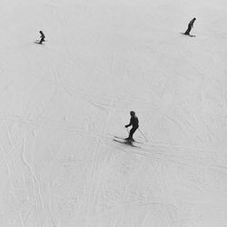 People skiing on beach during winter