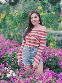 Portrait of smiling woman with pink flowers