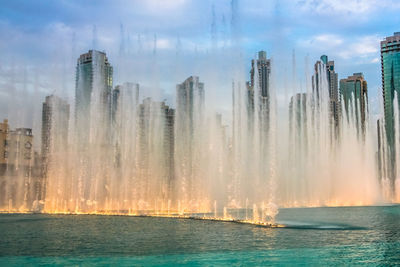 Panoramic view of city against cloudy sky