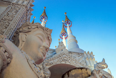 Low angle view of statue against clear blue sky